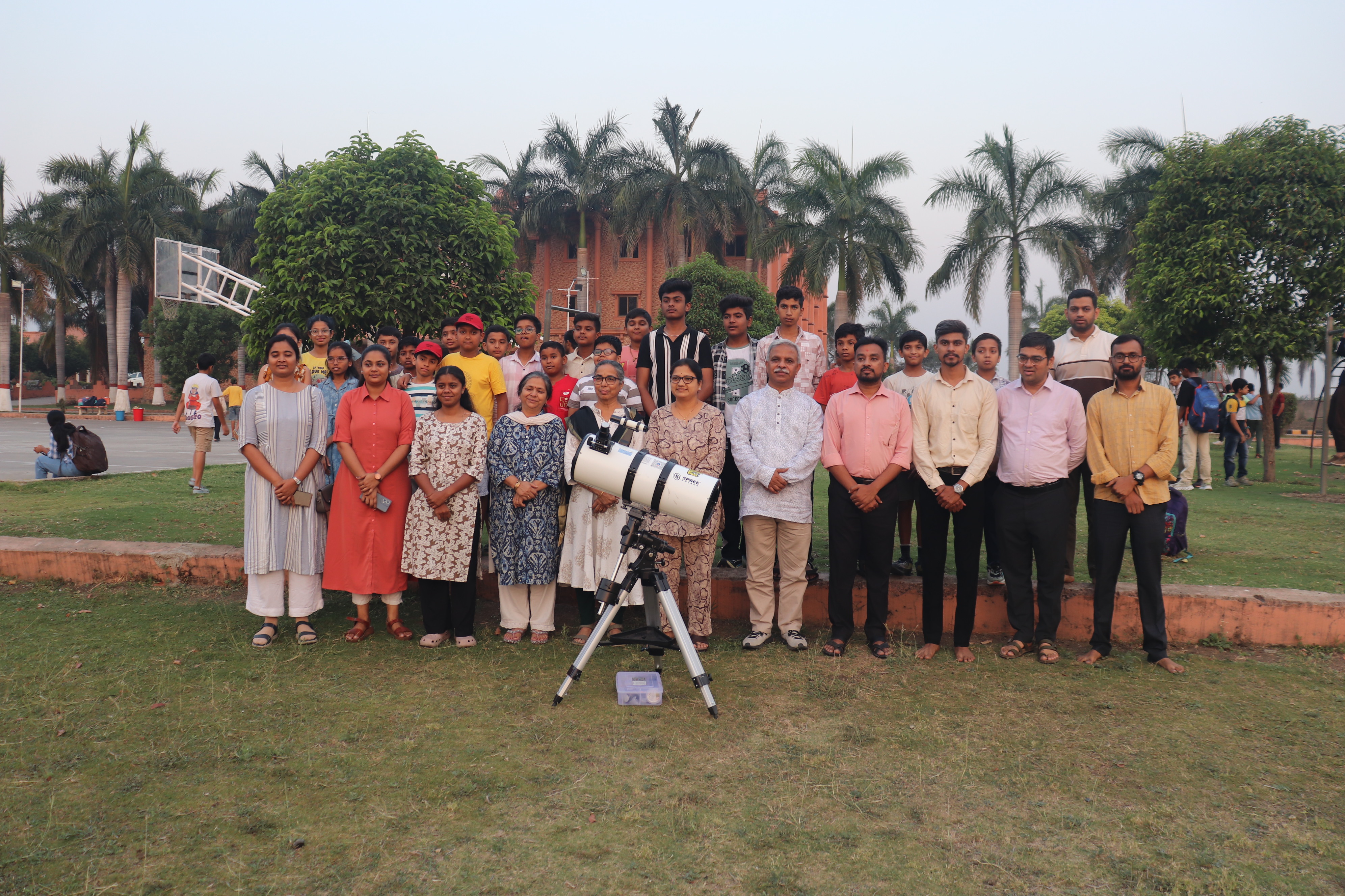 Group astronomy session with telescope